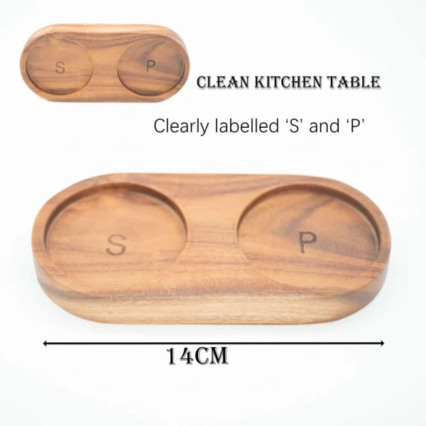 Handcrafted acacia wood salt and pepper grinders with ceramic mechanisms, displayed on a matching wooden tray with natural grain visible.