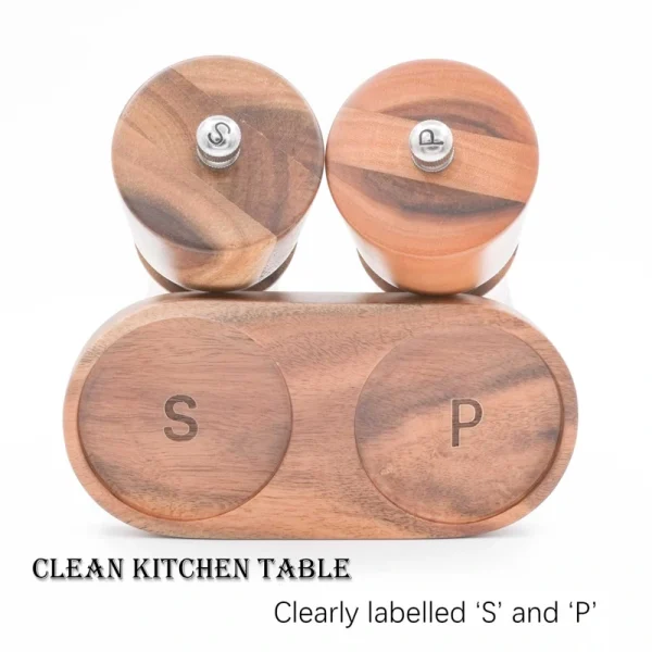 Handcrafted acacia wood salt and pepper grinders with ceramic mechanisms, displayed on a matching wooden tray with natural grain visible.