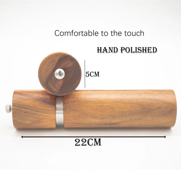 Handcrafted acacia wood salt and pepper grinders with ceramic mechanisms, displayed on a matching wooden tray with natural grain visible.