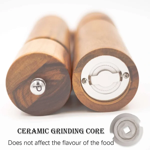 Handcrafted acacia wood salt and pepper grinders with ceramic mechanisms, displayed on a matching wooden tray with natural grain visible.