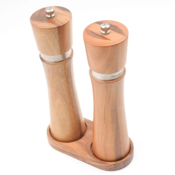 Handcrafted acacia wood salt and pepper grinders with ceramic mechanisms, displayed on a matching wooden tray with natural grain visible.